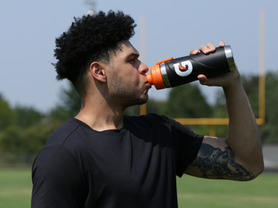 Athlete drinking Gatorade from bottle