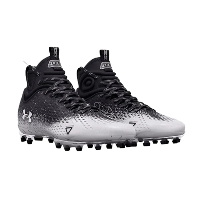 Black and white UA Spotlight LUX MC 2.0 cleats with lightweight breathable upper and multidirectional traction studs.